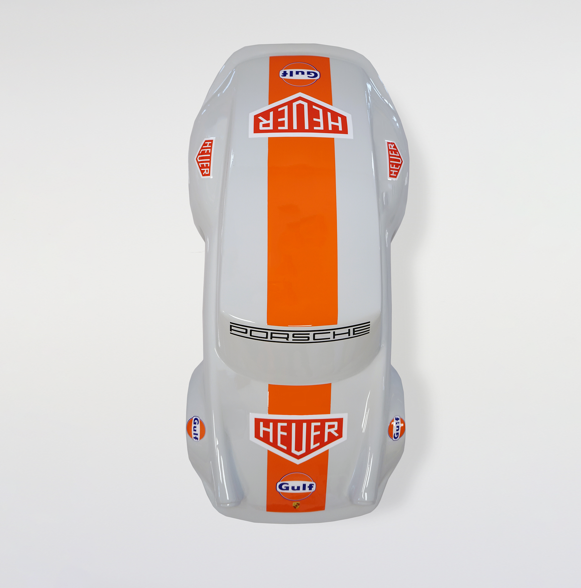 Car model 911 - motif 20 3 Top view of a grey racing car with an orange stripe down the center, displaying the logos