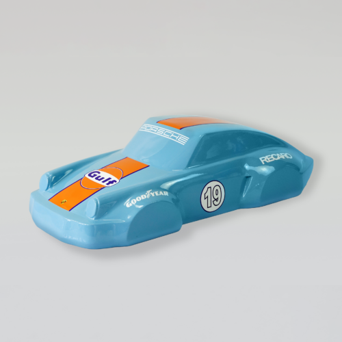 Blue toy race car with orange stripes and sponsor logos, including Gulf.