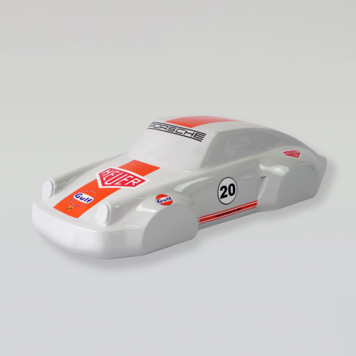 Model car with Porsche branding, number 20, and Heuer and Gulf logos on a white body with red accents.
