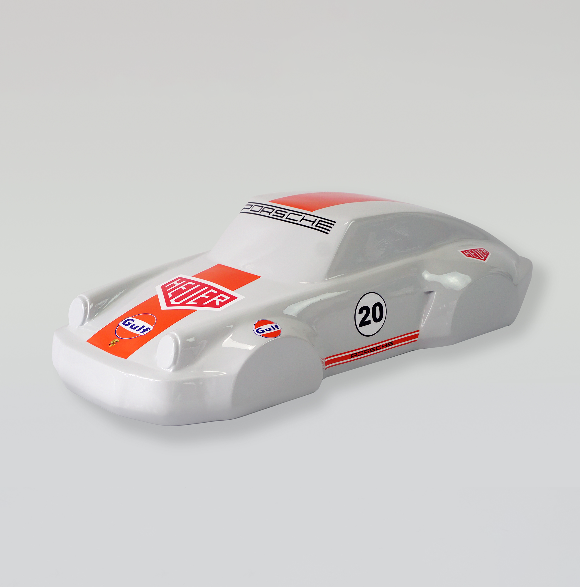Car model 911 - motif 20 1 Model car with Porsche branding, number 20, and Heuer and Gulf logos on a white body with red accents.
