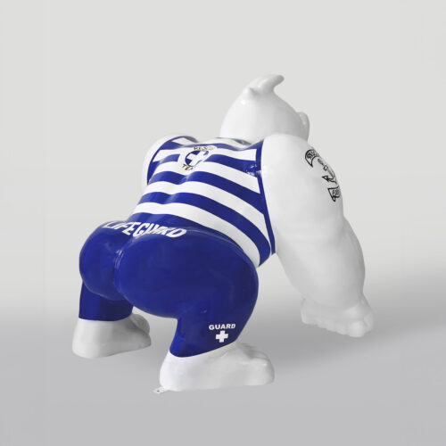Stylized sculpture of a muscular gorilla in a pose, painted to resemble a lifeguard with blue and white stripes, blue shorts with 