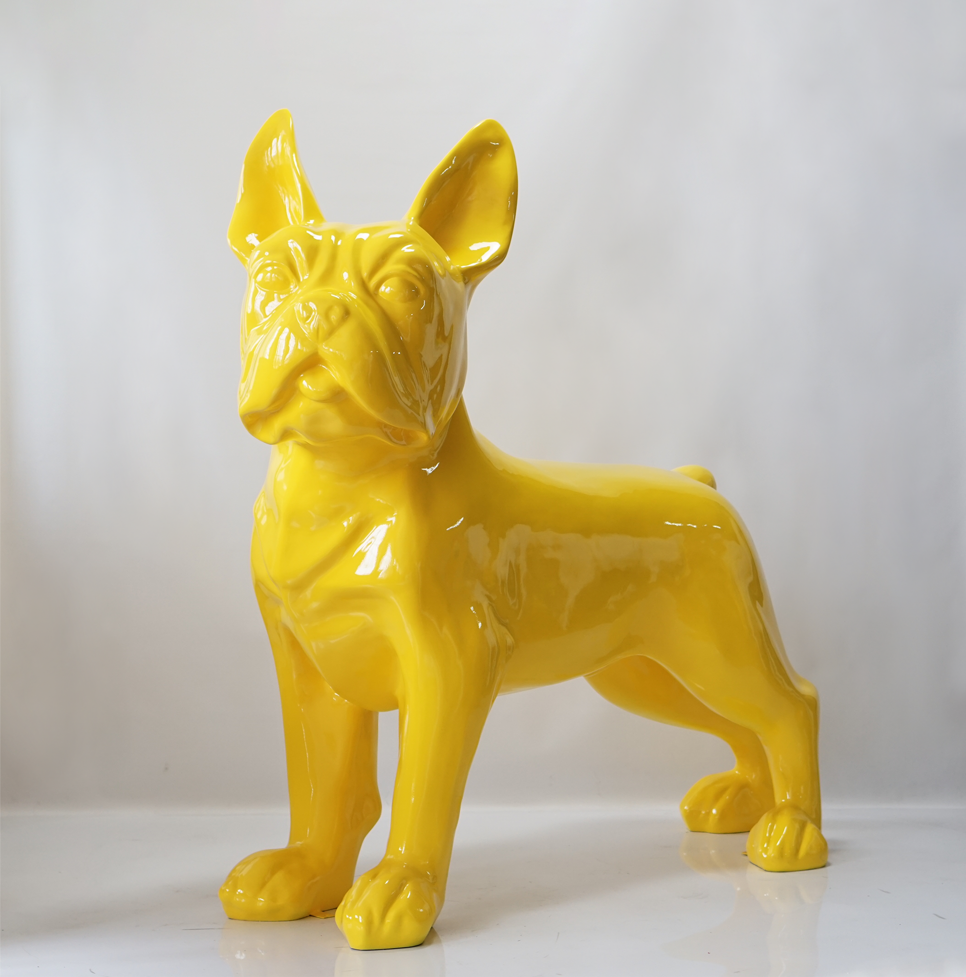 Large figure of a French Bulldog - Yellow 1 Yellow ceramic statue of a French Bulldog on a white background.