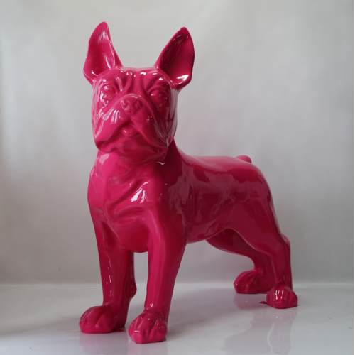 A glossy, bright pink sculpture of a French Bulldog standing on all fours against a plain background.