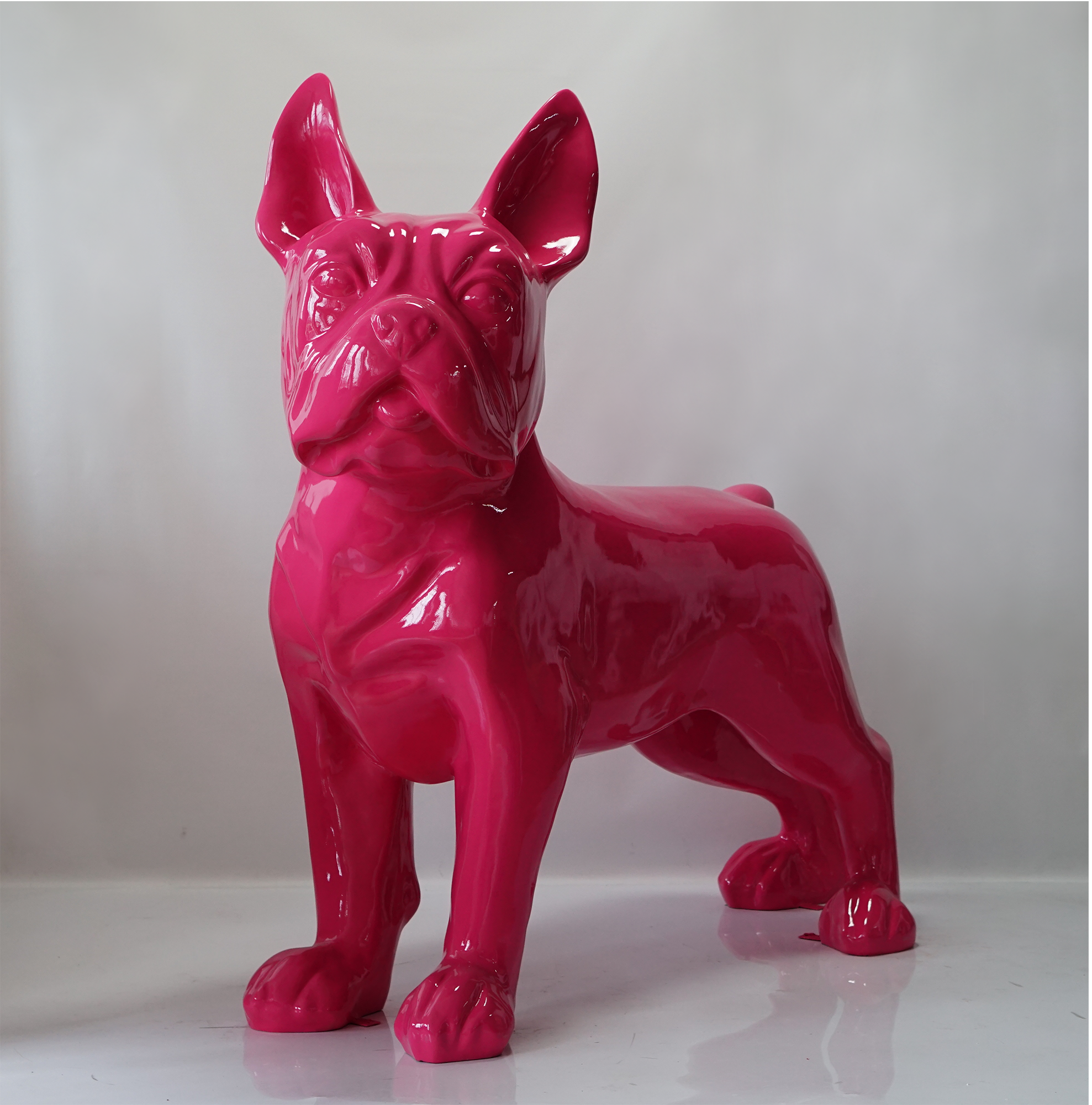Large figure of French Bulldog - pink 1 A glossy, bright pink sculpture of a French Bulldog standing on all fours against a plain background.