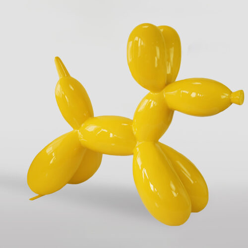 Yellow balloon dog sculpture against a light background.