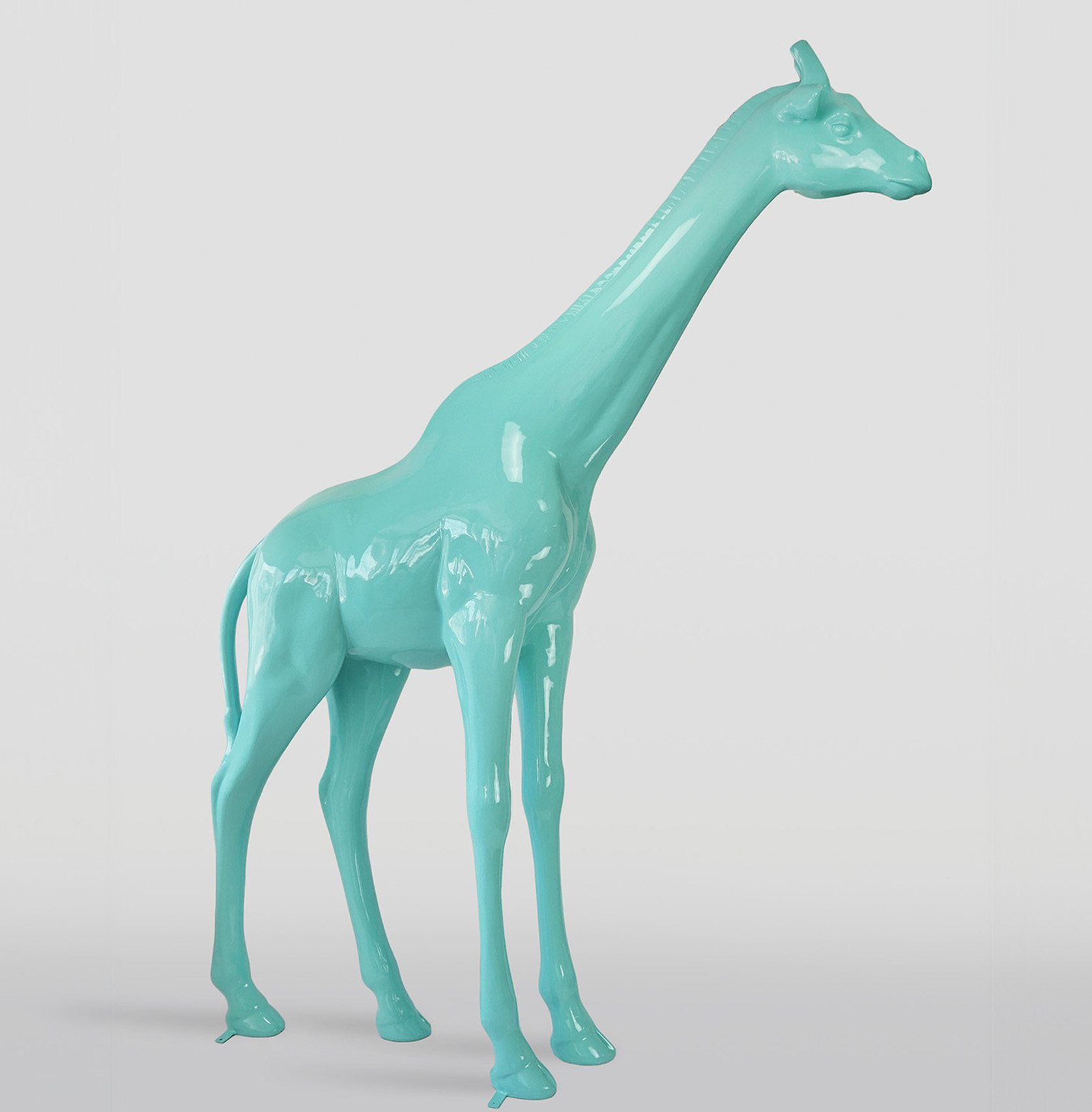 Large life-size giraffe figure - white 3 Turquoise giraffe sculpture against a light gray background.