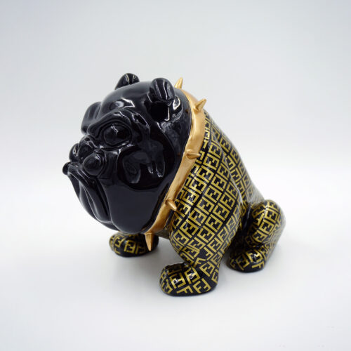 Black ceramic bulldog figurine wearing a gold and black patterned vest and spiked gold collar.