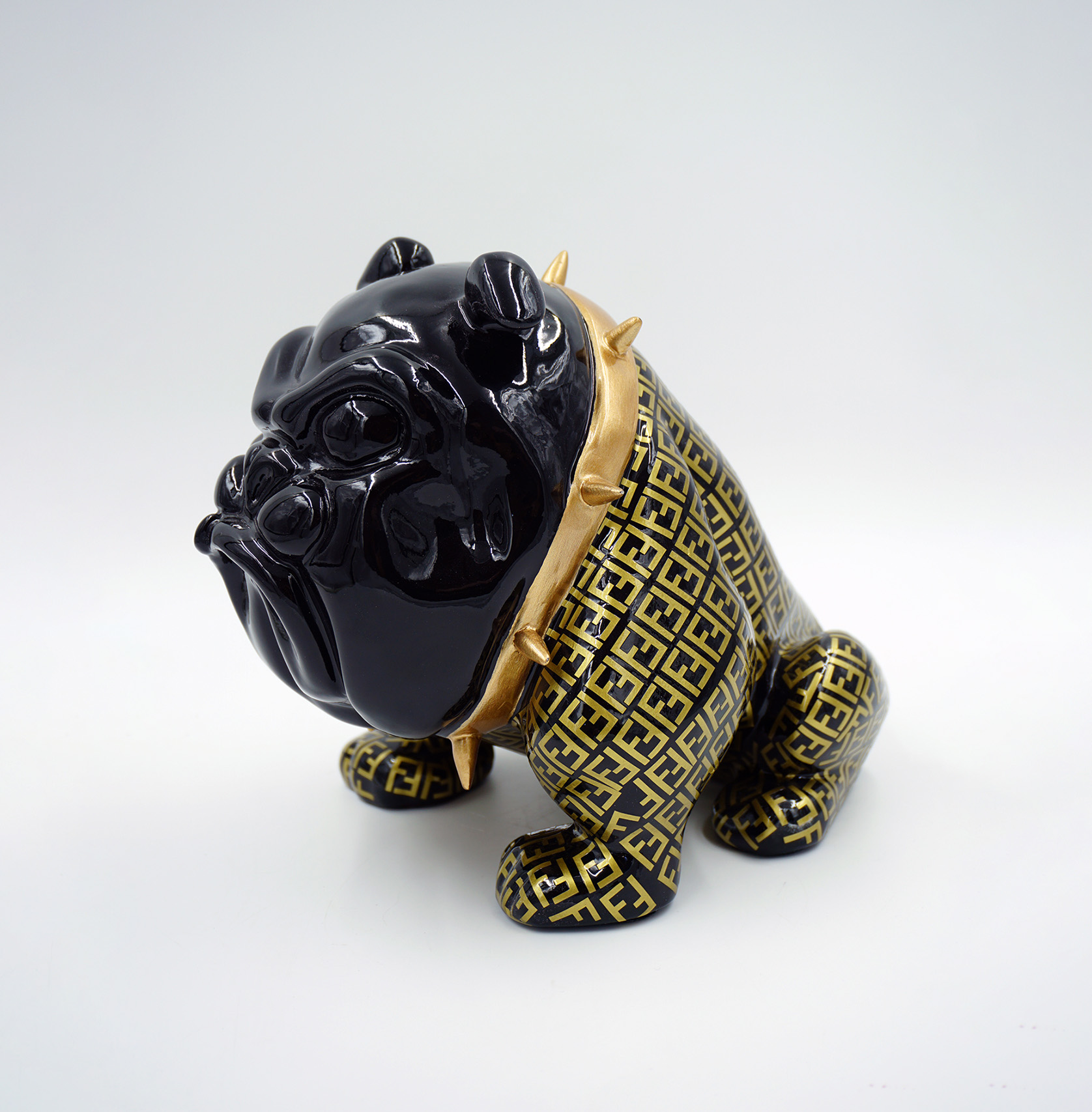 Bulldog Avella dog 22cm - wrapped motif F 1 Black ceramic bulldog figurine wearing a gold and black patterned vest and spiked gold collar.