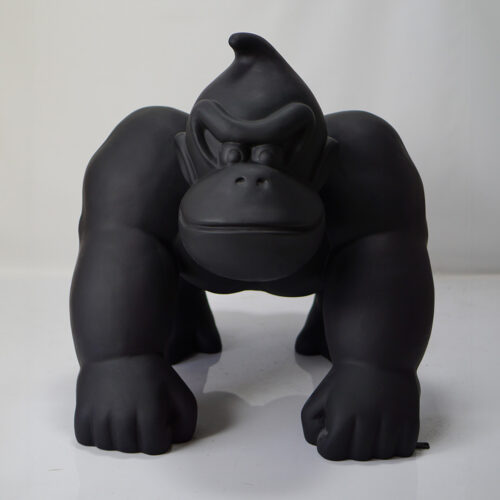 Black-colored figurine of a crouching gorilla with a stern expression.
