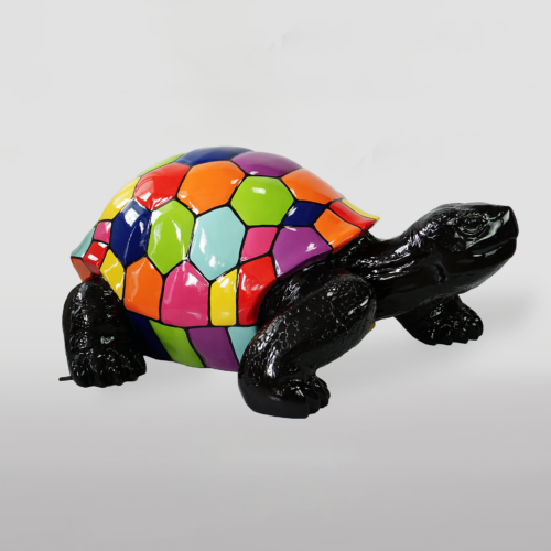 Colorful turtle sculpture with a black body and a multicolored patchwork shell.