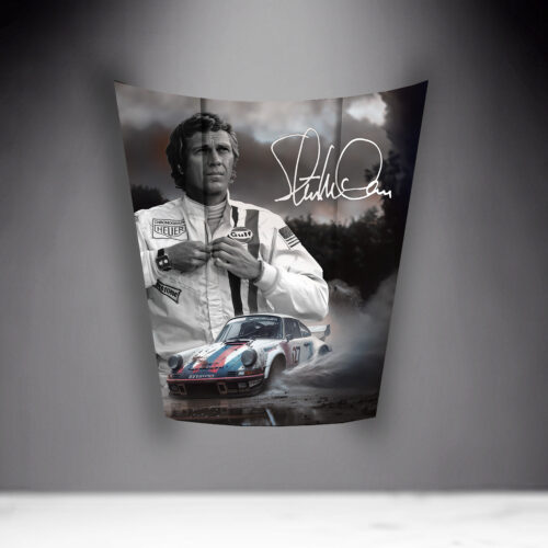Black and white poster featuring a man in a racing suit and a race car with the signature of Steve McQueen.