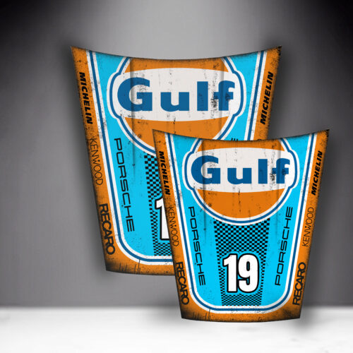 Two vintage-style Gulf Porsche racing car hoods with blue and orange designs, displaying the Gulf logo, the number 19 on one and 14 on the other, and sponsor names Michelin, Kenwood, and Recaro.