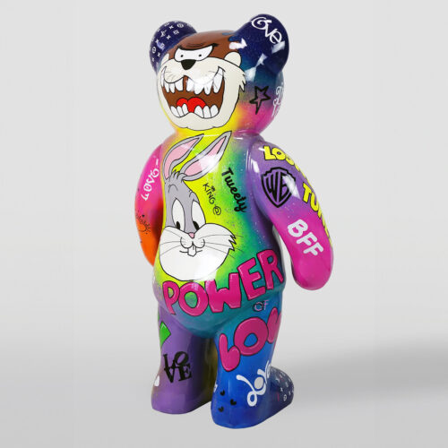 Colorful bear sculpture adorned with cartoon characters and words like