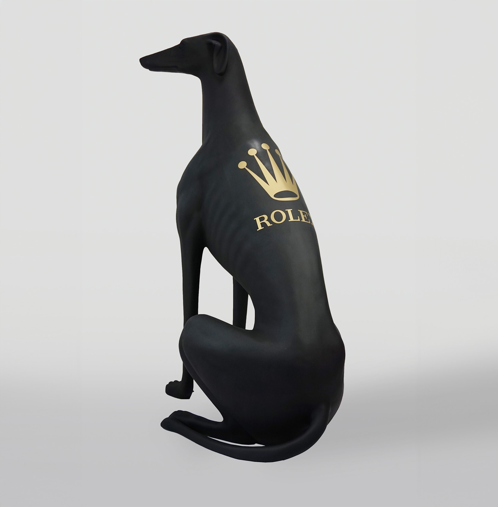 Large black greyhound dog figure RLX 2 Black sculpture of a greyhound dog with a gold Rolex logo on its back.