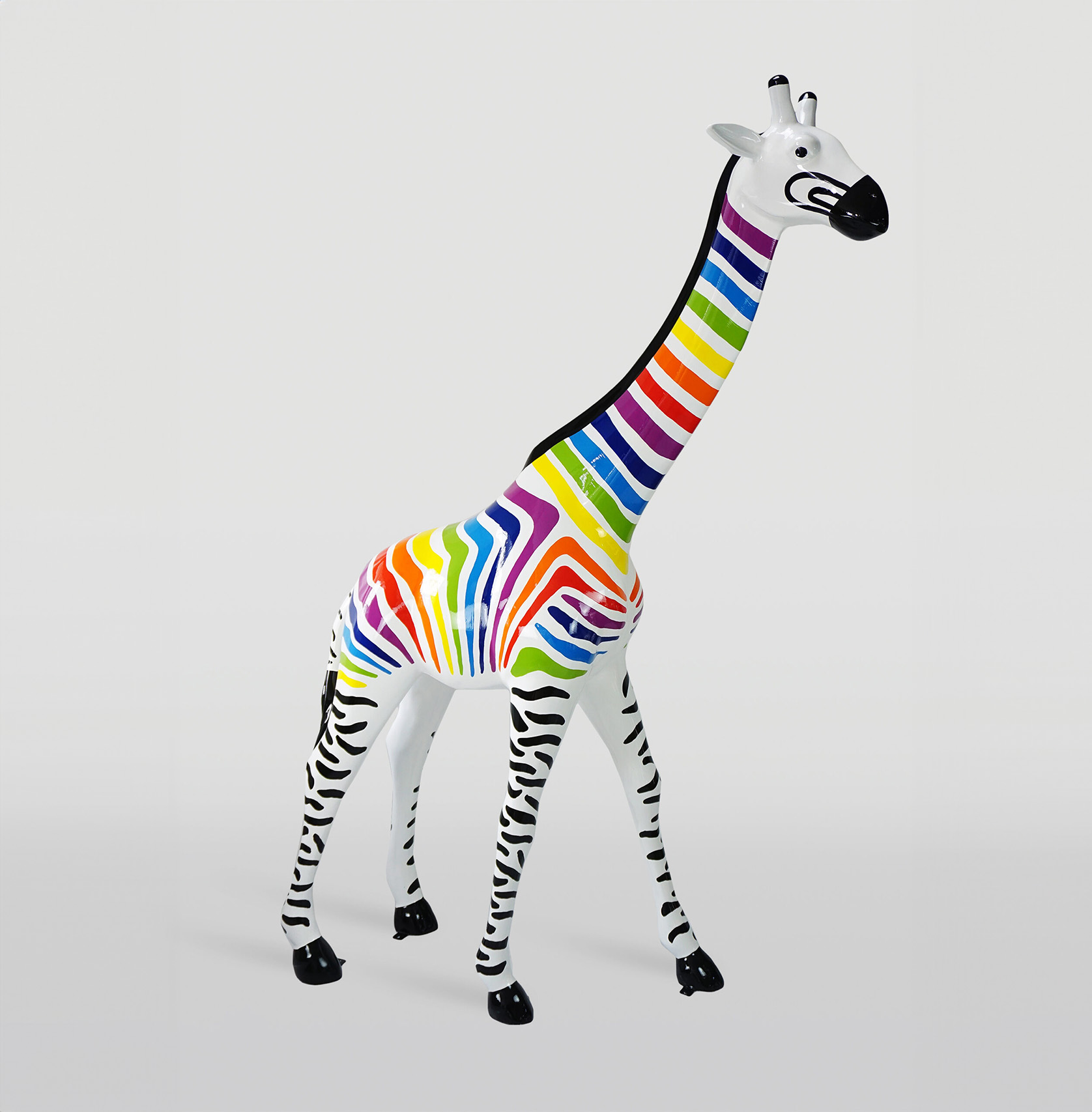 Large giraffe 230cm color zebra 1 Colorful giraffe sculpture with black and white zebra-striped legs and a rainbow-striped body and neck.