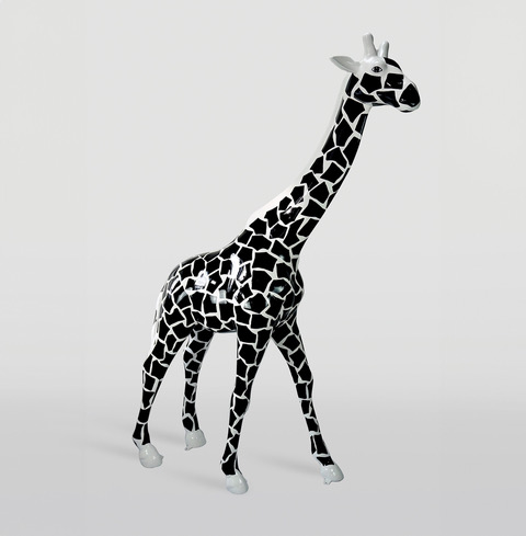 Sculpture of a giraffe with a black and white mosaic pattern, standing on all four legs.