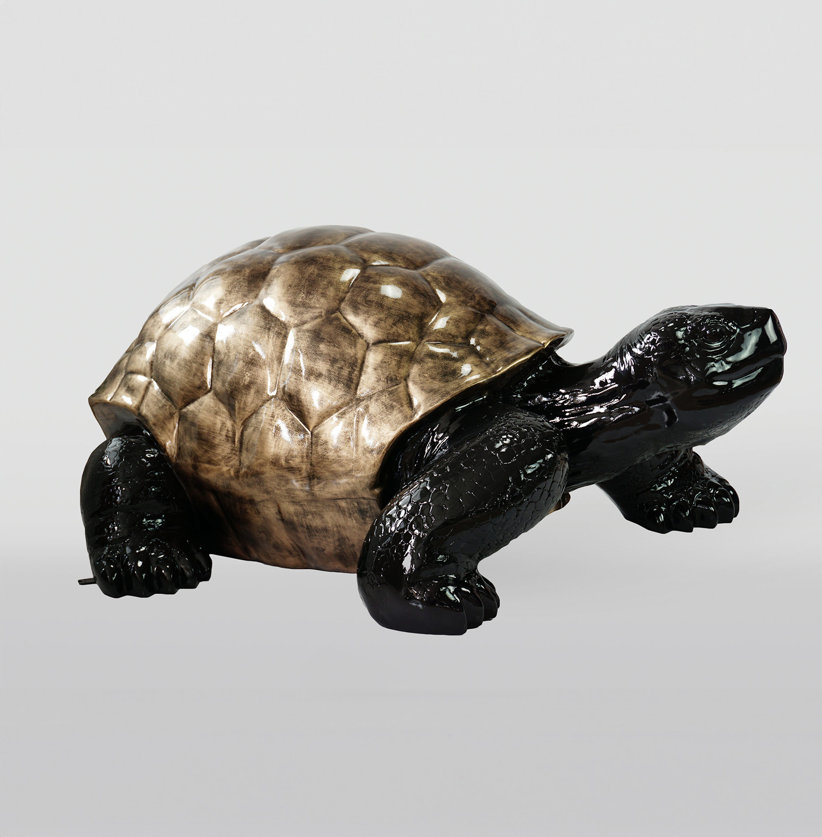 Large figure of a walking turtle - Gold Patina 1 Sculpture of a turtle with a bronze-colored shell and black body.