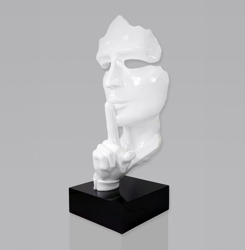 White abstract face sculpture with finger on lips on a black base.