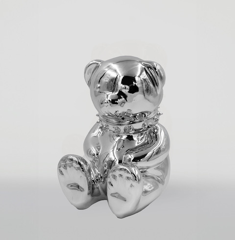 Silver bear-shaped sculpture with a shiny, reflective surface and a smooth finish.