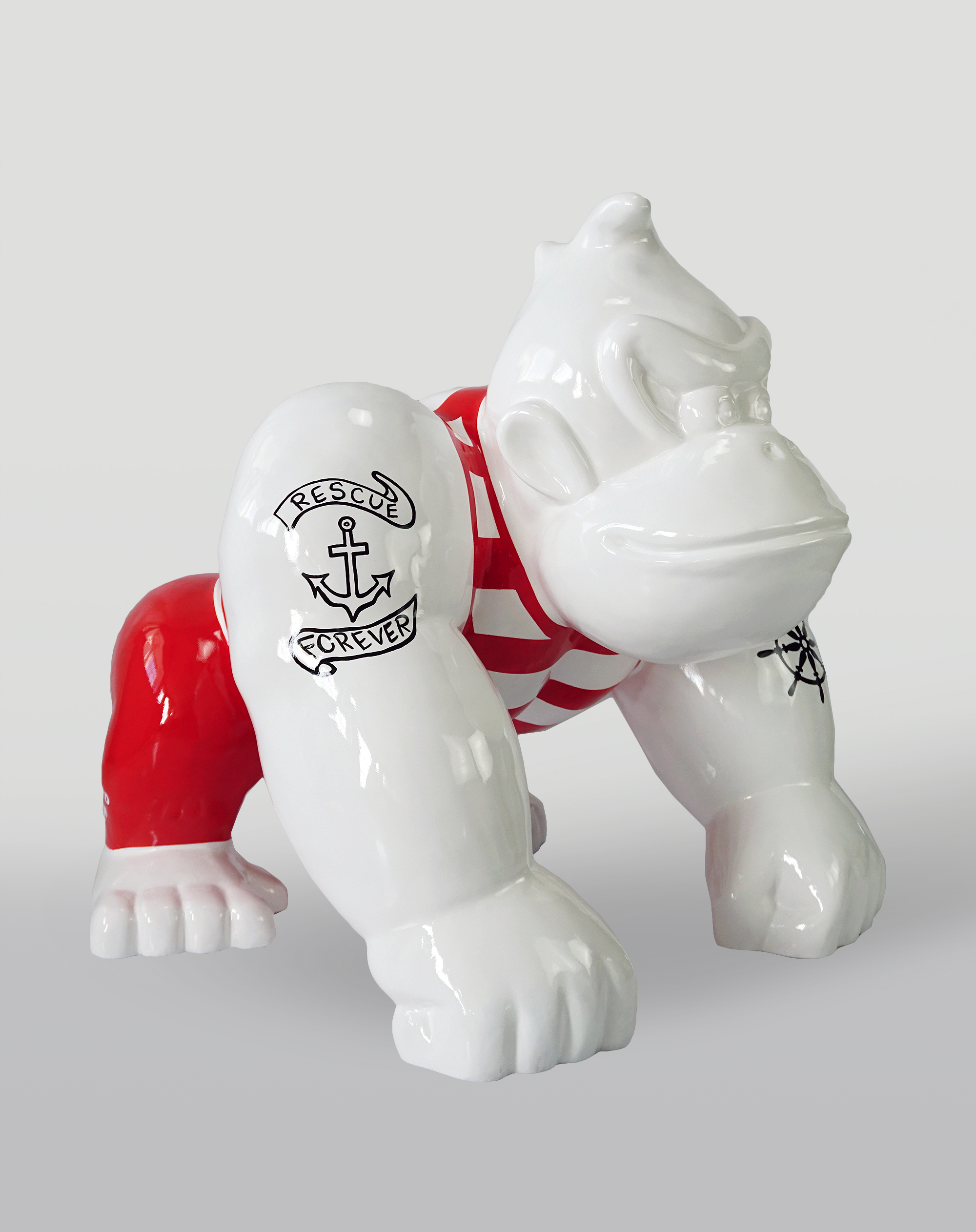 Donkey Kong - Red Sailor 1 Ceramic sculpture of a gorilla in a crouching pose with red and white stripes on its body and black tattoo designs on its arms.