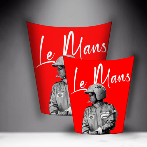Two Le Mans-themed posters with vintage race car drivers in helmets depicted in black and white, on a red background with 