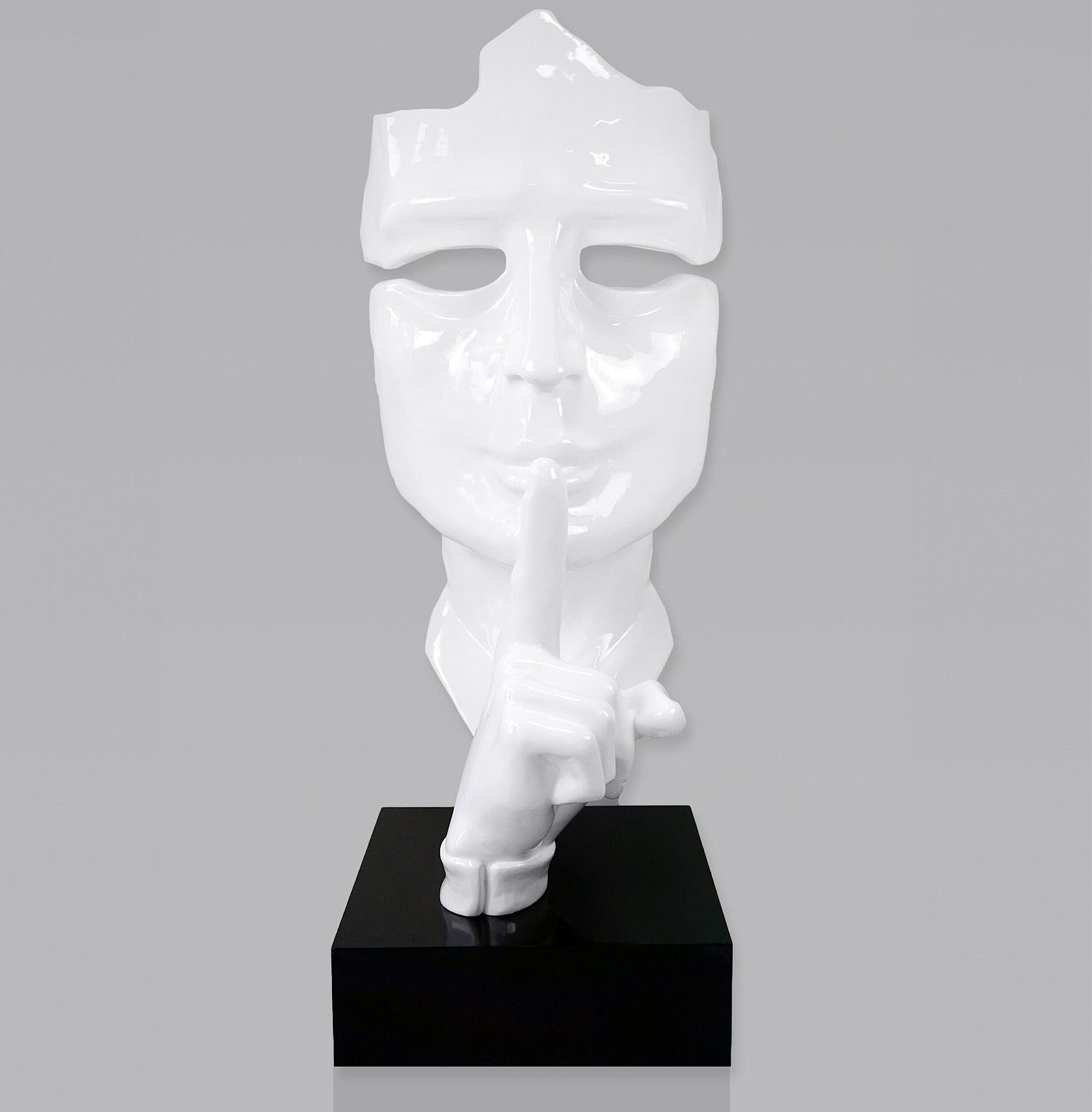 Large mask on stand - white 1 White mask sculpture with finger to lips in a
