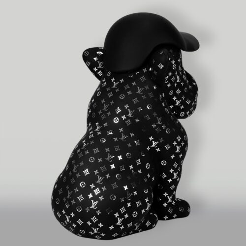 A black statue of a dog wearing a black helmet, covered in a pattern of white and silver Louis Vuitton logos.