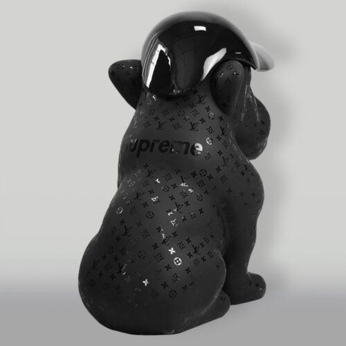 Black sculpture of a dog wearing a cap, covered in Louis Vuitton monogram patterns and marked with the Supreme logo.