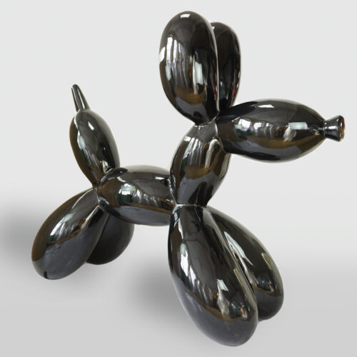 A shiny black sculpture of a balloon dog, reflecting light on its surface.
