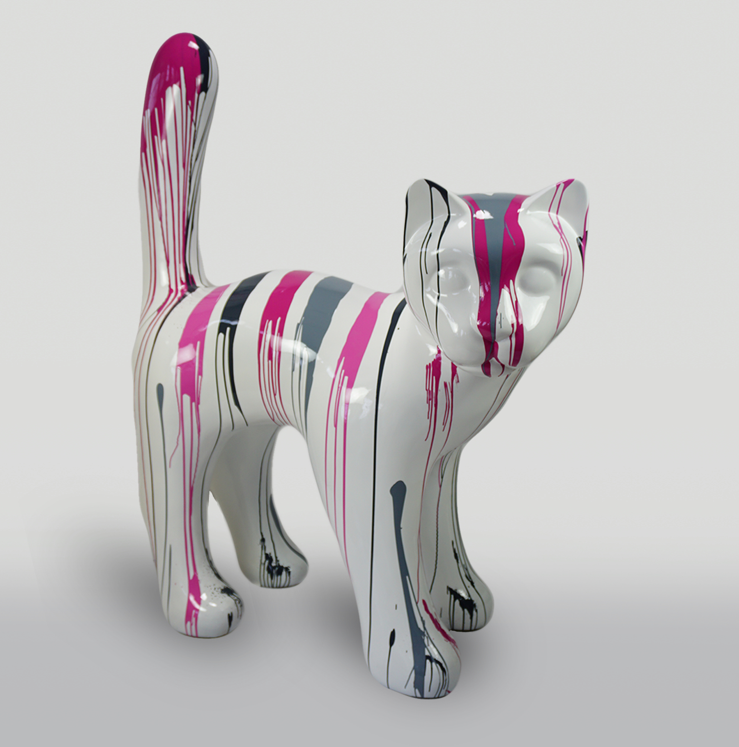 Large Pink Trash Cat 1 A white cat sculpture with drip-style paint streaks in pink, black, and gray.