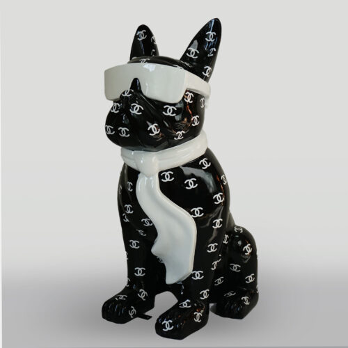 A black ceramic dog figurine wearing white sunglasses and a white scarf, covered in a pattern of interlocking white 