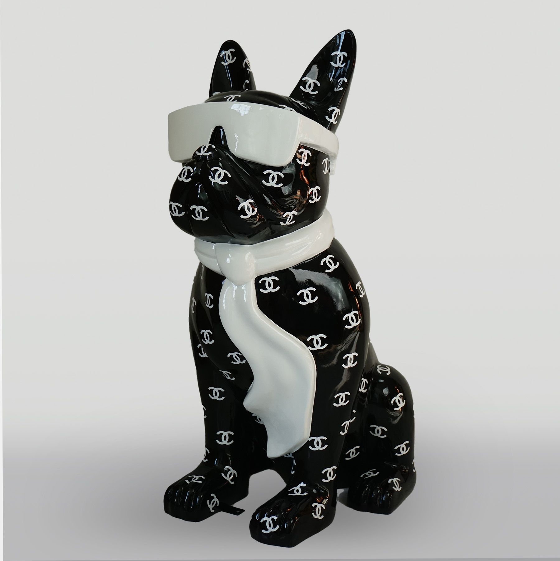 Dog figure bulldog with tie and glasses - CH Black 1 A black ceramic dog figurine wearing white sunglasses and a white scarf, covered in a pattern of interlocking white