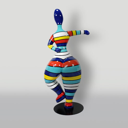 Colorful abstract sculpture of a woman with a striped pattern in various colors including blue, yellow, orange, red, and white, standing on one leg on a black base.