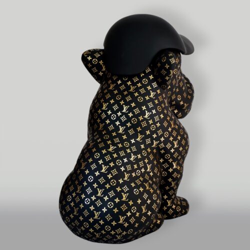 Black bear sculpture with gold Louis Vuitton monogram print and a black cap.