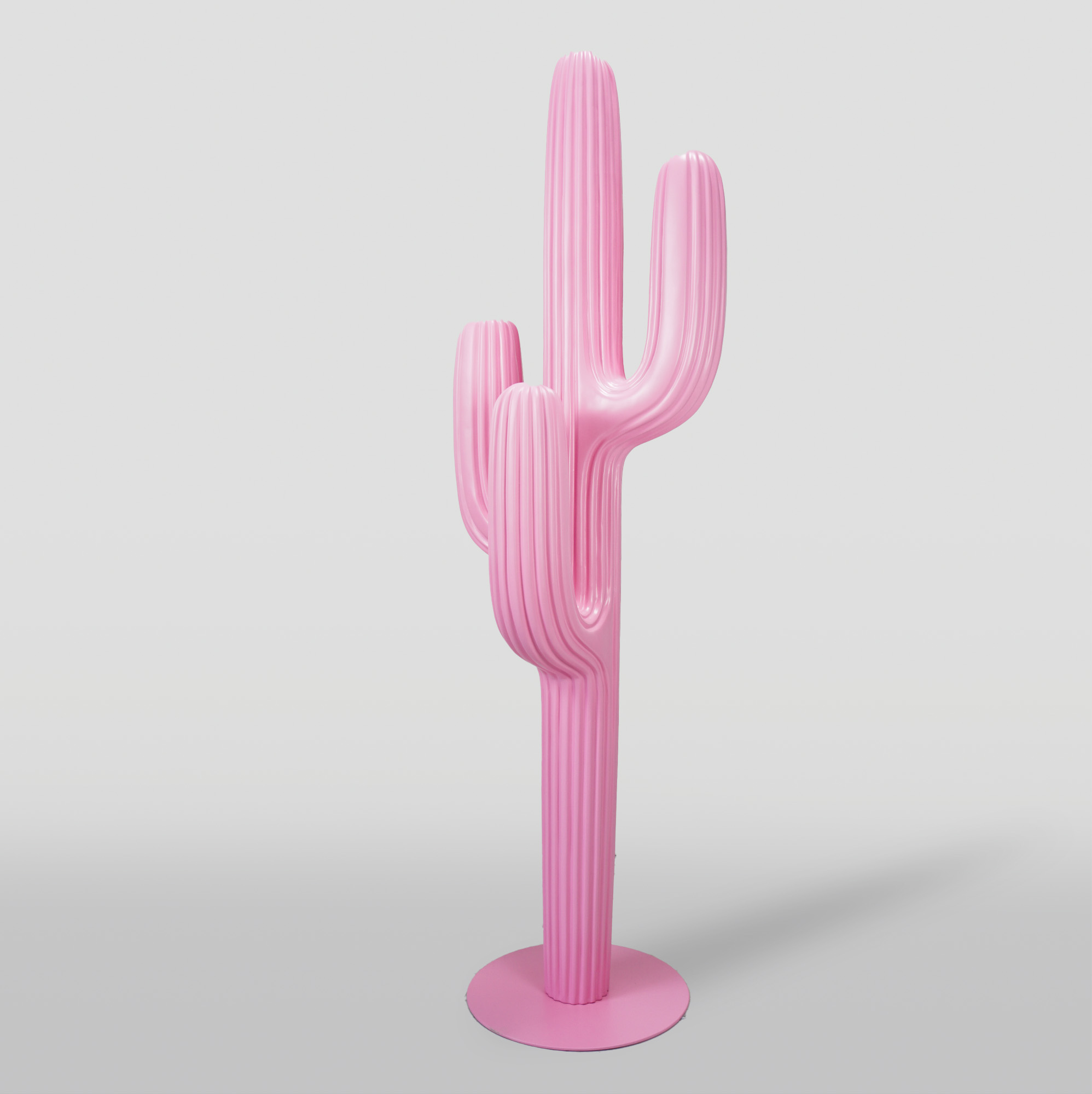 Pink sculptural cactus with a smooth, glossy finish and a round base against a plain background.