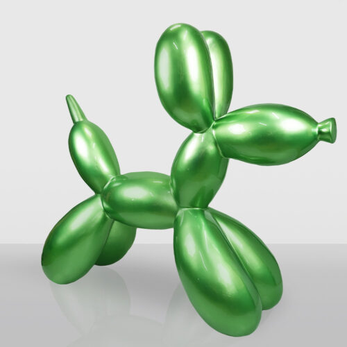 Shiny green balloon sculpture shaped like a dog, standing on a reflective surface with a neutral gray background.