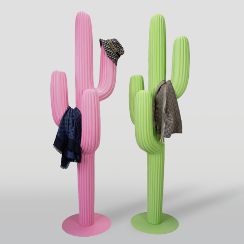 Two colorful cactus-shaped coat racks, one pink with a hat and scarf, and one green with a jacket.