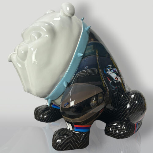 Ceramic bulldog figurine with a white, glossy head and a body featuring images of cars and carbon fiber texture.