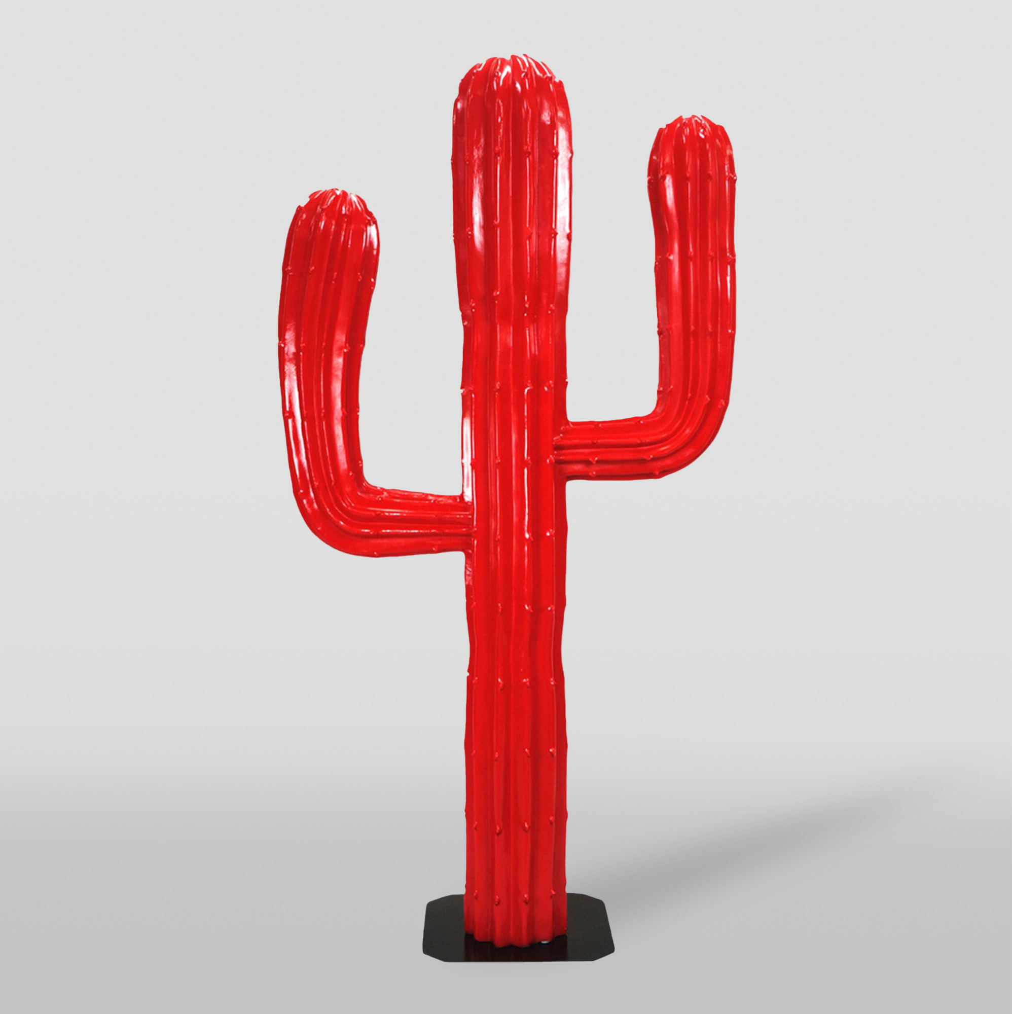 Cactus 180 cm - Red 1 Red cactus-shaped sculpture on a black base.