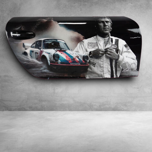 Painted car door featuring a racing scene with a Porsche 911 rally car and a man in a racing suit against a gray concrete background.