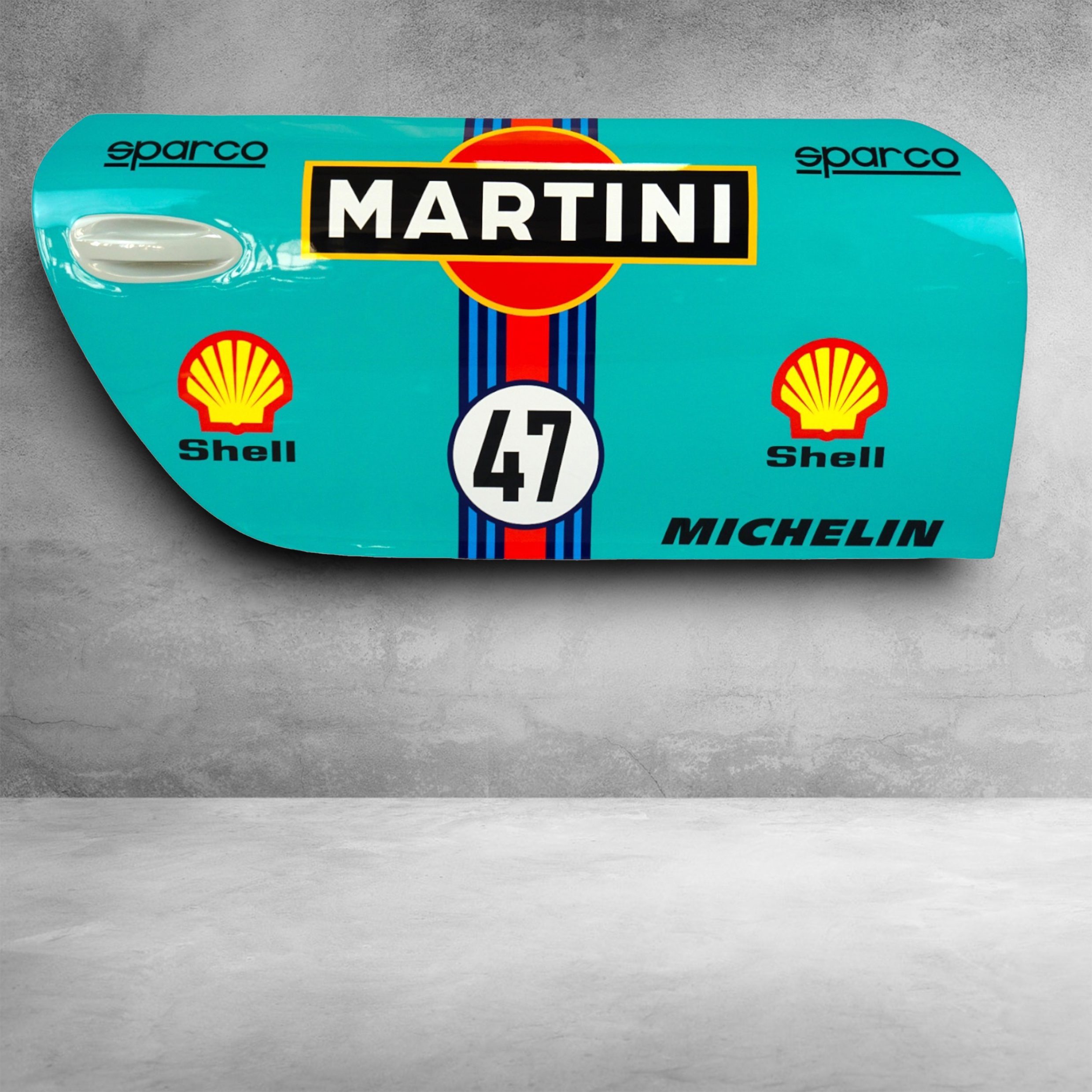 Car doors 911 - motif 4 1 Light blue car door with Martini racing logo, number 47, and sponsor logos for Sparco, Shell, and Michelin, displayed against a grey concrete background.