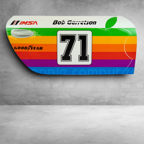 Colorful race car door panel with number 71, Apple logo, and sponsor logos including Goodyear and IMSA.