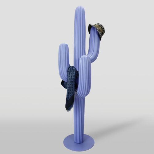A lavender-colored cactus-shaped coat rack with a patterned scarf draped over one arm and a bucket hat placed on another arm, against a plain background.