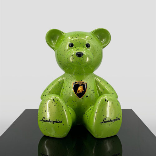 Green ceramic bear with Lamborghini logo and black speckles, seated on a black surface.