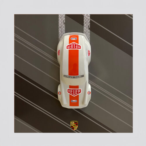 Top view of a white and red model car with 