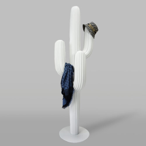 White cactus-shaped coat rack with a dark blue scarf draped over it and a patterned hat placed on one of its arms.
