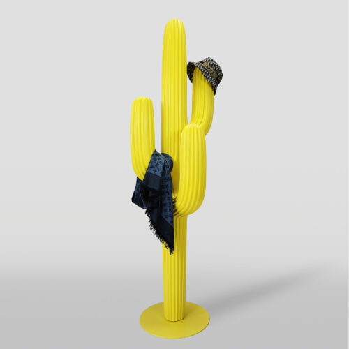 Yellow cactus-shaped coat stand with a black patterned scarf and a beige patterned hat hanging on it.