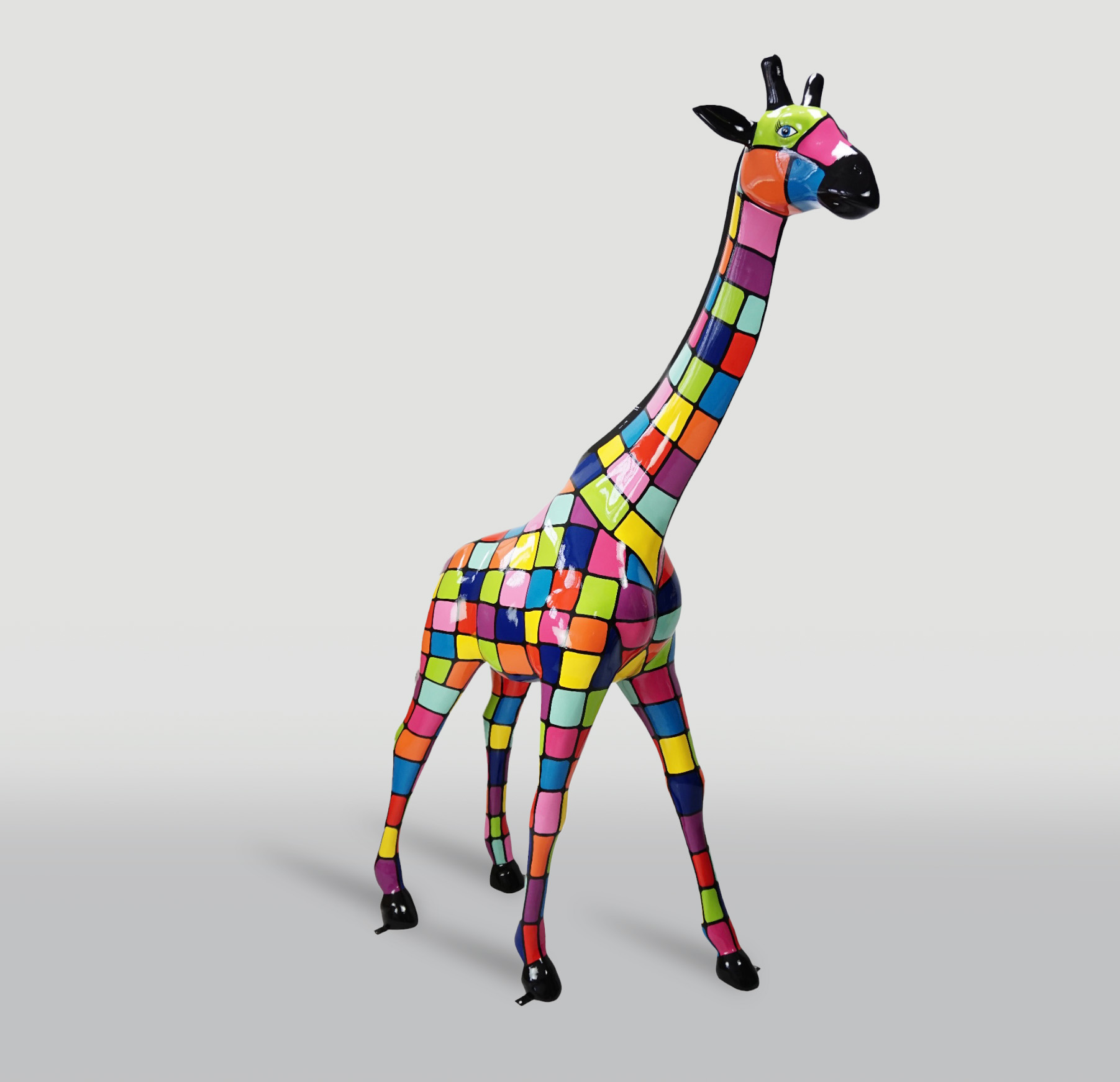Large giraffe 230cm - smartie version 1 Sculpture of a giraffe covered in colorful, checkerboard-style squares.