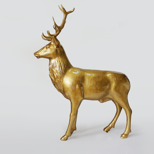 Golden deer statue with antlers on a white background.