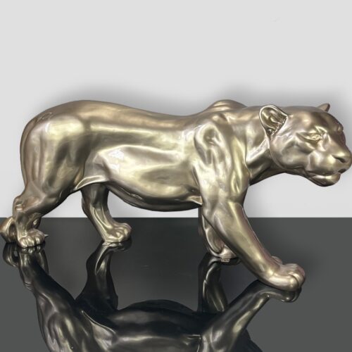 A shiny silver panther sculpture on a reflective black surface.